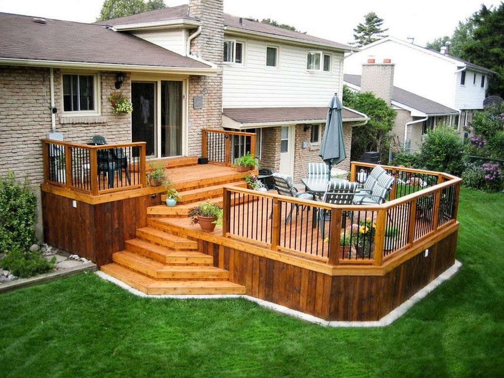 Custom wood deck with elegant railings overlooking a beautiful backyard