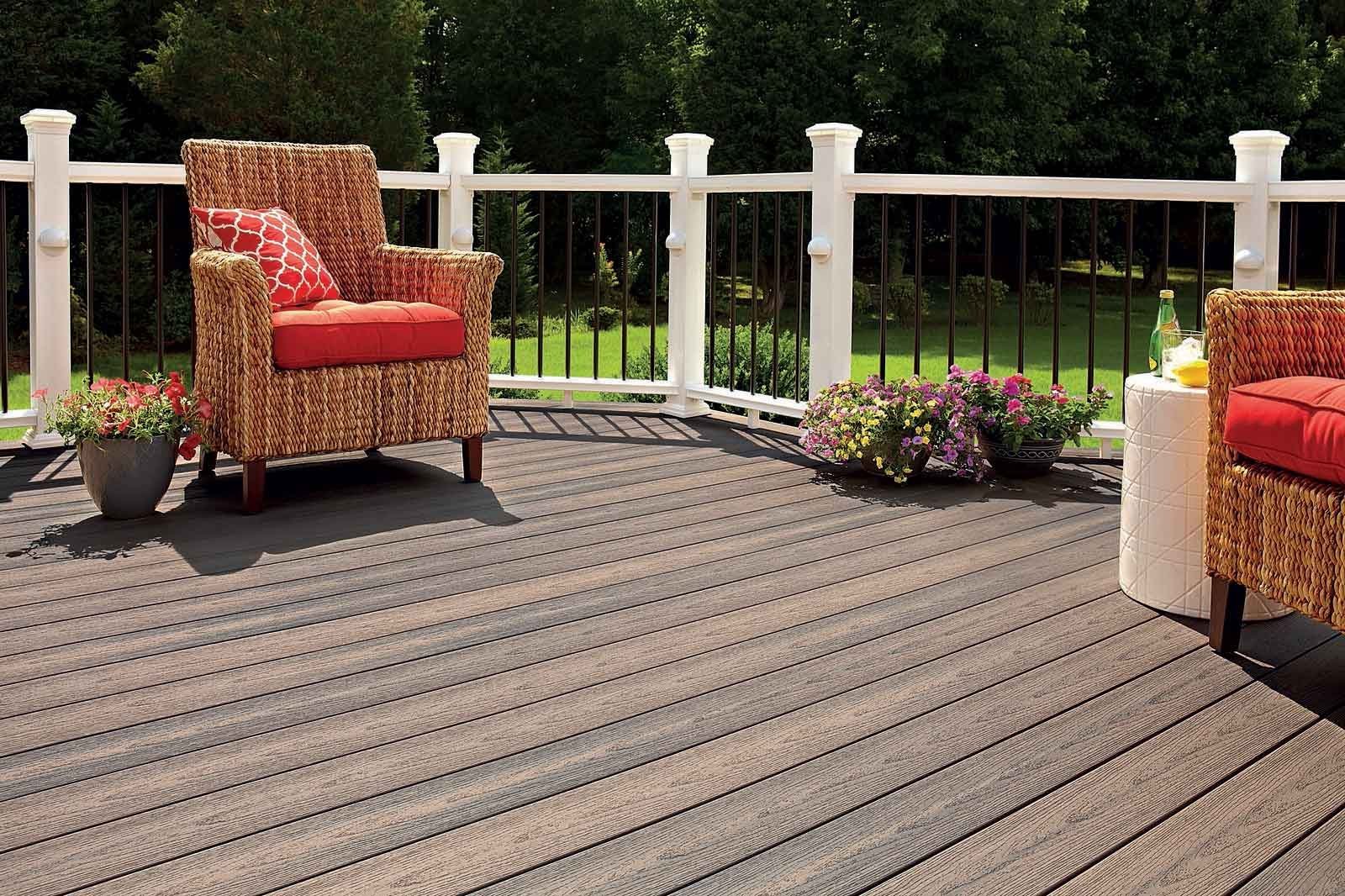 Timber deck furnished as an outdoor living space with railings and planting alongside