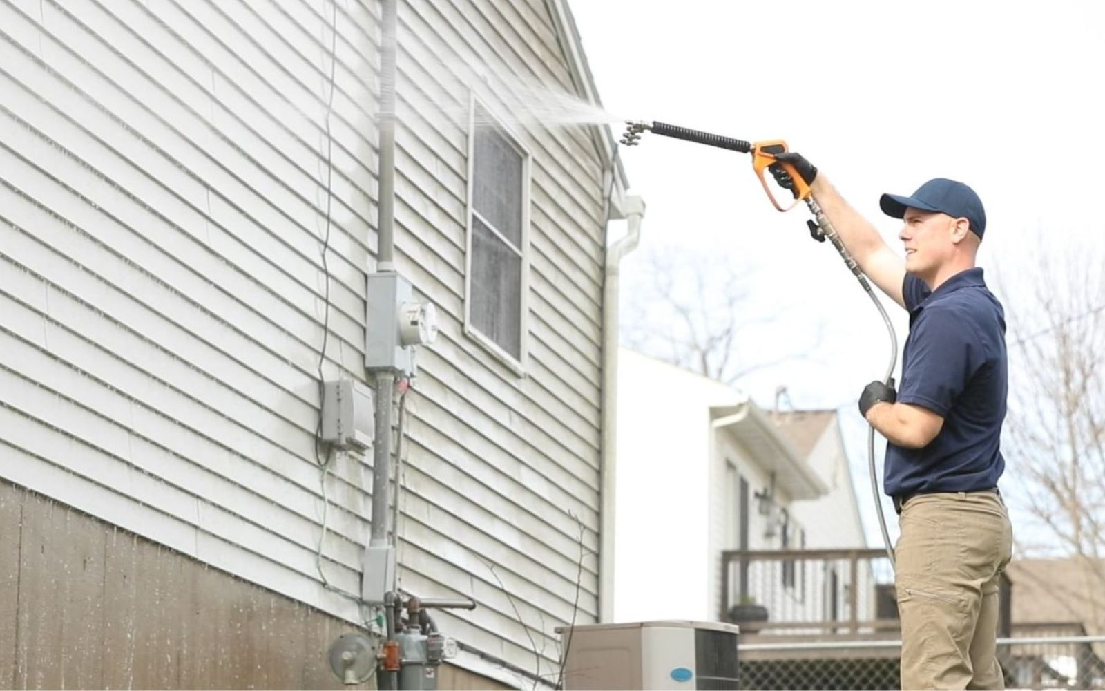 Prestige Home Experts washing years of mildew and salt build-up off residential siding