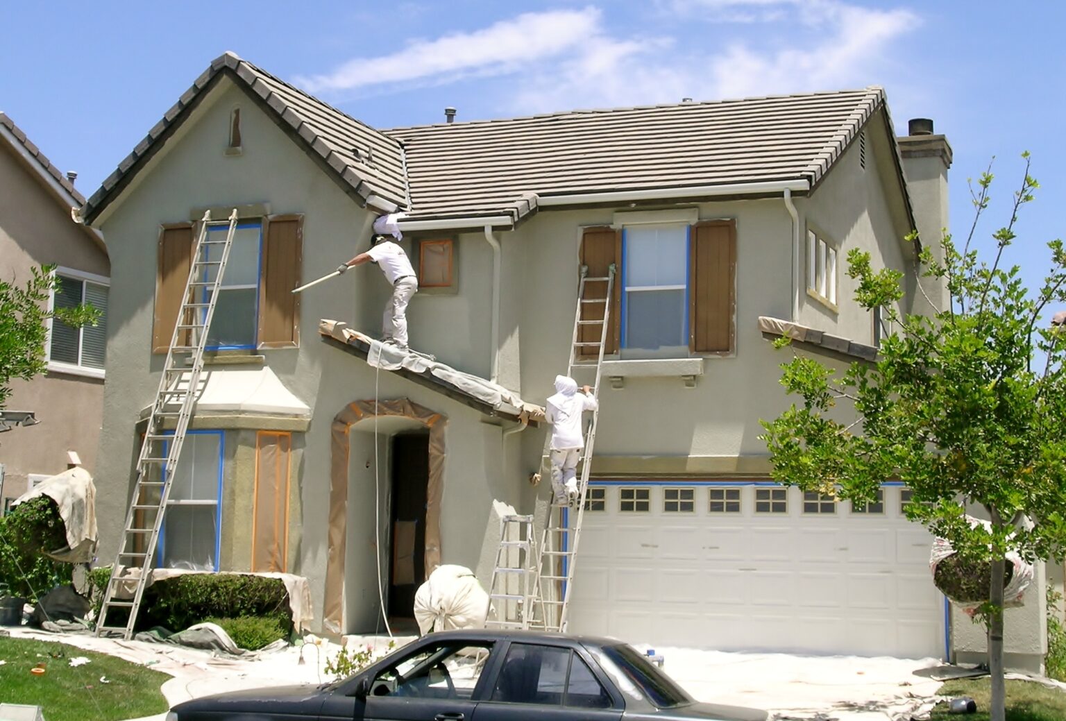 Freshly painted residential exterior with crisp white trim against coastal siding