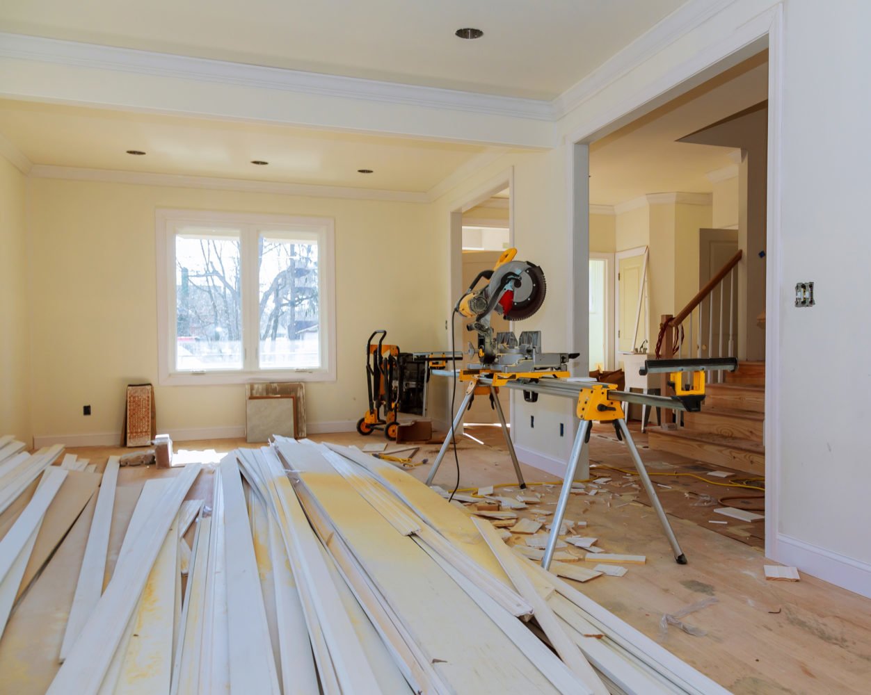 Interior renovation in progress with new framing and materials staged on site