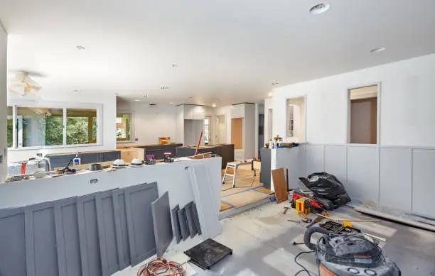 Kitchen area mid-renovation with new cabinetry and finishes being installed